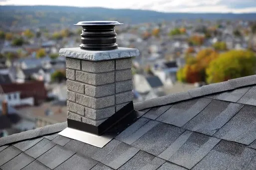 Restored masonry chimney with new cap on an older home near Driving Park